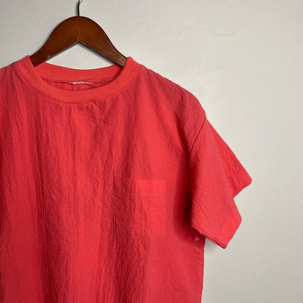 Vintage pink top with front pocket about a size medium small stain on front show